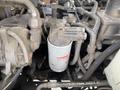 Close-up of a 2012 Toro Groundsmaster 5910 engine compartment showing various components including fuel lines filters and wiring