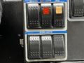 Control panel with switches for beacon, auxiliary lights, PTO, and work lights on a 2012 Autocar Xpert