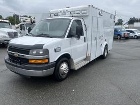 A 2016 Chevrolet Express van designed as an ambulance with a white exterior and light bar on top