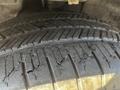 A close-up view of a worn tire tread showing deep grooves and cracks on a 2013 Lincoln MKT tire