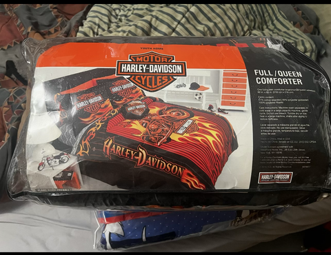 A Harley Davidson bed comforter featuring bold colors and motorcycle graphics in a fiery design designed for full or queen size beds