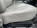 Close-up of a gray leather seat in a 2016 Chevrolet Express showing the cushion and seat mechanism without any visible wear