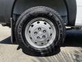 Close-up of a silver wheel with a black Nexen tire branded with 'Rugged Terrain' and a RAM logo in the center