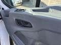 Interior door panel of a 2016 Ford Transit featuring the door handle and window controls