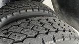 Close-up of two rugged tires showing detailed tread patterns and dirt accumulation on the surface