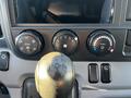 The image shows the interior controls of a 2014 Mitsubishi Fuso FE featuring climate control knobs and a gear shift lever