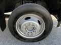 Close-up of a 2018 Ford F-550 tire with a silver rim and visible lug nuts on a black tire tread