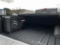 A 2016 Ford F-150 truck bed featuring a diamond plate tool box on the left side