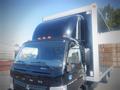 A black 2013 Mitsubishi Fuso FE 160 truck with a shiny cab and a large boxy cargo area at the back