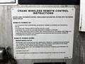 A 2016 Ford F-550 vehicle displaying a sign with instructions for operating a crane wireless remote control system