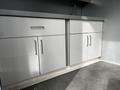 A 40 foot custom climate controlled storage container with sleek white cabinets featuring handles and a modern design