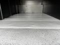 2013 Ford F-650 with a large cargo area featuring a smooth concrete floor and walls that are dark in shade
