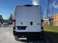 A 2019 RAM Promaster van viewed from the rear showcasing its large white cargo door and distinctive RAM logo