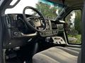 Interior view of a 2017 Chevrolet Express van showing the steering wheel dashboard and front seats