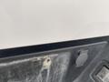 Close-up view of a white 2019 Ford F-150 showcasing the tailgate and rear bumper with visible wear and dirt marks