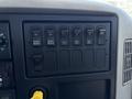 Dashboard control panel of a 2018 International DuraStar featuring various switches for park regen inhibit PTO work light and cab ratio