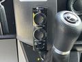 A Pioneer speaker control interface with knobs for gain and frequency mounted near a gear shift in a 2017 Mercedes-Benz Sprinter