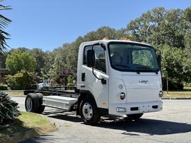 A 2024 VMC 1200 truck chassis in white with no cargo bed visible showcasing a compact design and large front headlights