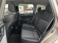 Interior view of a 2016 Subaru Forester showing the rear seats with black fabric upholstery and a two-tone design