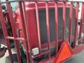 A red 2014 Toro Groundmaster 5910 with a rear grille and warning triangle on the back, viewed from a low angle showing its industrial design and features
