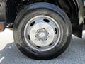 Close-up of a silver wheel and tire from a 2020 Hino 155 with a detailed tread pattern and a five-bolt hubcap