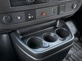 The image shows the interior console of a 2016 GMC Savana with three cup holders and various control buttons