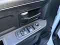 Image of a RAM 5500 door panel featuring a handle and control buttons for window and lock functions