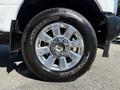 A close-up of a shiny silver wheel with a polished metal rim and black Michelin tire fitted on a 2017 Ford F-350 SD