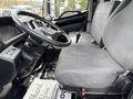 Interior of a 2017 Hino 338 showing a steering wheel and driver seat with fabric upholstery and control panel details