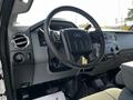 Interior view of a 2016 Ford F-550 showing the steering wheel dashboard and control panel