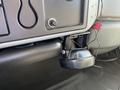 A black horn attached to a grey panel in a 2007 International 7300 truck's interior with visible wiring and controls