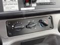 The control panel of a 2005 Freightliner M2 106 featuring three knobs for fan speed and temperature settings with labels for their functions