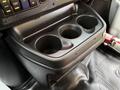 Three cup holders in the front console of a 2019 Chevrolet Express