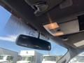 The interior view of a 2014 Ford F-150 showing the rearview mirror and overhead console with lights and controls