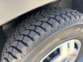 Close-up of a rugged tire from a 2016 RAM Promaster showing deep treads designed for traction and stability
