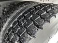 Close-up of a tire tread from a 2011 International 4400 showcasing deep grooves and rugged surface designed for traction and durability