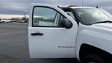 A white 2013 Chevrolet Silverado 1500 with the driver's door open displaying the "SILVERADO" badge on the side