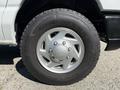 Close-up of a silver wheel with a Goodyear tire on a 2011 Ford Econoline showcasing the tire tread pattern and the five-spoke wheel design