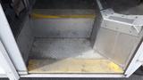 Steps leading into a vehicle with a metal surface and yellow indicators on the edges