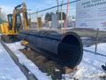 A 2000 plow with a 12-foot attachment designed for snow removal displayed on a snow-covered ground with a rounded edge and a robust design