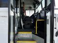 Interior view of a 2022 Blue Bird Vision school bus featuring the driver's seat control panel and steps leading up to the door