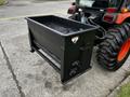 A black metal bucket attachment for a tractor with a grid top and side handles designed for lifting and transporting materials