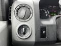 Close-up of the control panel of a 2009 Ford Econoline showing dials for temperature and light settings