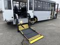 A 2017 Chevrolet Express with a wheelchair ramp extended from the rear passenger area showing the interior seating and accessibility features