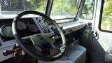 Interior view of a 2004 Freightliner MT45 with a large steering wheel and dashboard featuring gauges and controls