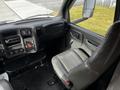 Interior of a 2006 GMC C5000 featuring a driver's seat and dashboard with controls and a stereo system