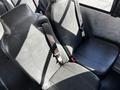 Two grey leather seats with seatbelts in a 2022 Blue Bird Vision bus interior