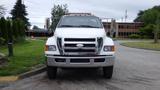 A white 2008 Ford F-750 truck with chrome accents and side mirrors facing forward