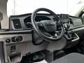Interior view of a 2023 Ford Transit highlighting the steering wheel dashboard and control panel