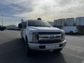 A 2017 Ford F-350 SD in white with a chrome grille and headlights facing forward